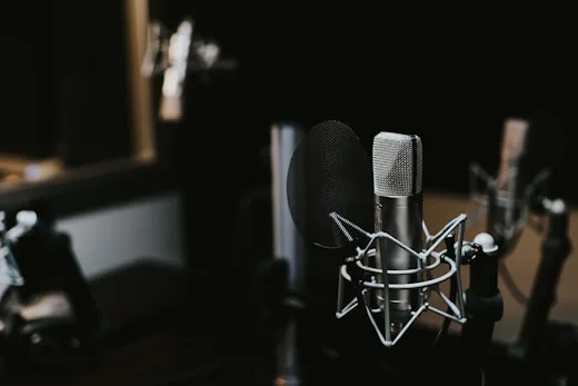 A studio condenser microphone with a pop filter is used for high quality music production.