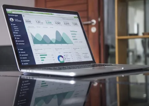 A laptop screen shows a data analytics dashboard relevant to film and video production.