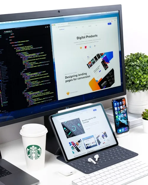 A modern workspace shows a computer, tablet and smartphone, ideal for creative arts projects.